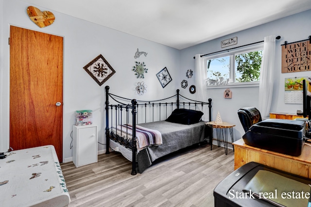 bedroom featuring light wood-style flooring