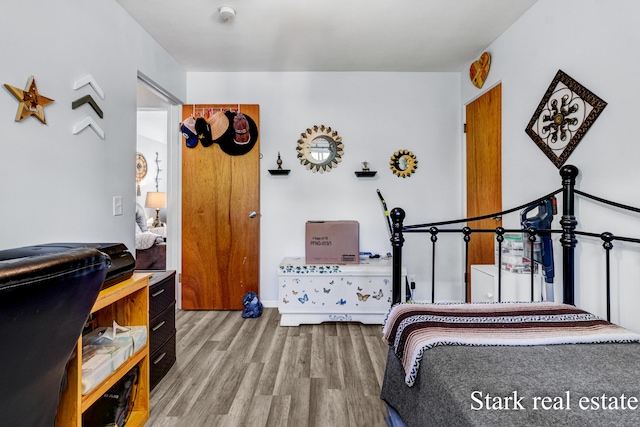 bedroom featuring wood finished floors and baseboards
