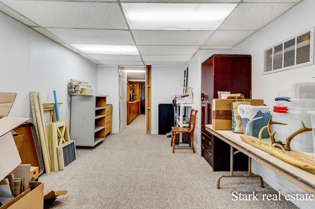 carpeted home office with a drop ceiling