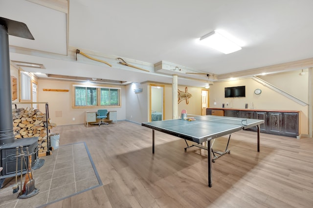 3118 Pratt Ln, Attica, MI 48412 - game room with a wood stove, light wood-style flooring, and baseboards
