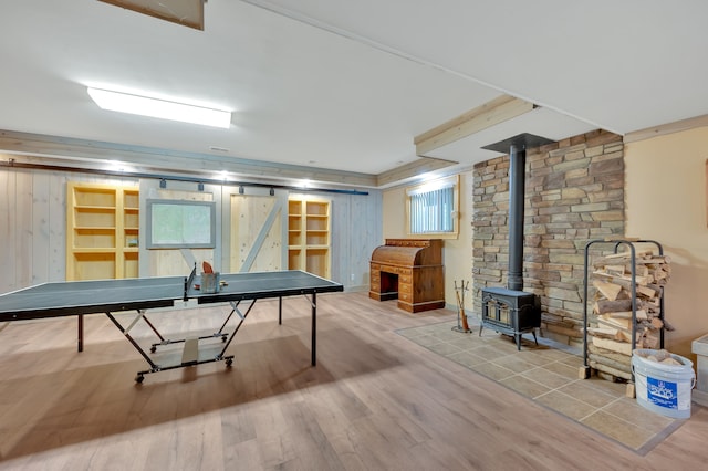 3118 Pratt Ln, Attica, MI 48412 - rec room featuring a wood stove, wood finished floors, and wooden walls
