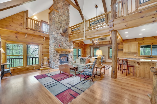 3118 Pratt Ln, Attica, MI 48412 - living area with wood finished floors, plenty of natural light, beam ceiling, high vaulted ceiling, and a stone fireplace