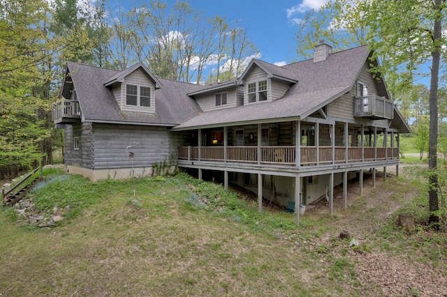 3118 Pratt Ln, Attica, MI 48412 - back of property featuring a balcony, a chimney, a shingled roof, and a sunroom