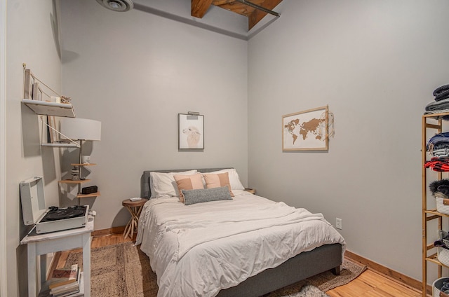 bedroom featuring wood finished floors and baseboards