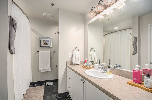 full bath featuring tile patterned flooring, vanity, and baseboards
