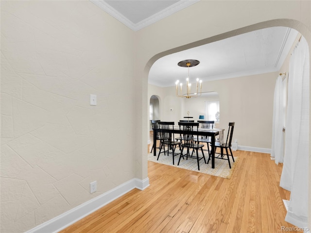 17524 Woodingham Dr, Detroit, MI 48221 - dining space with arched walkways, ornamental molding, light wood-style floors, baseboards, and a chandelier