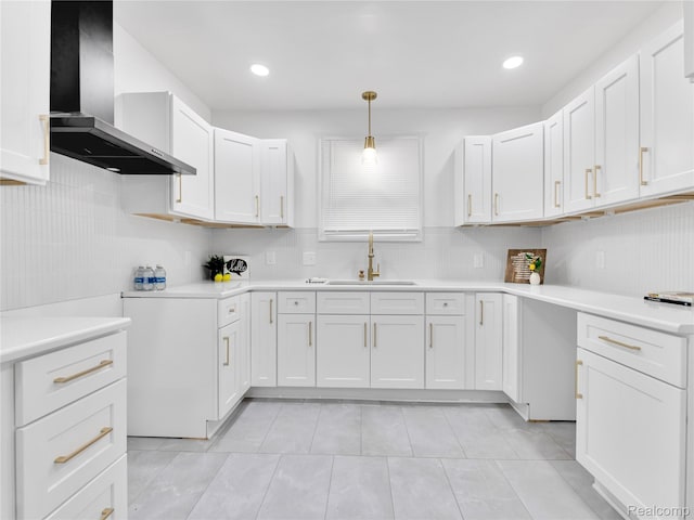 17524 Woodingham Dr, Detroit, MI 48221 - kitchen featuring wall chimney exhaust hood, a sink, tasteful backsplash, light countertops, and light tile patterned floors