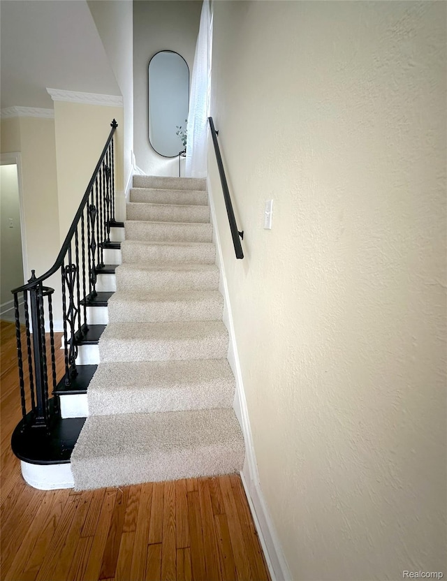 17524 Woodingham Dr, Detroit, MI 48221 - stairway with crown molding, wood finished floors, and baseboards