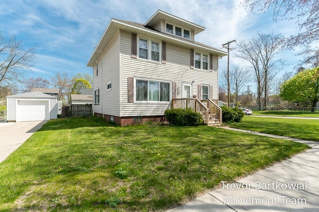 2200 Morton Ave, Muskegon, MI 49441 - american foursquare style home featuring an outbuilding, driveway, and a garage
