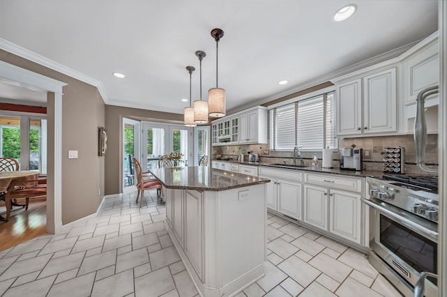 3123 Fairgrove Ter, Rochester Hills, MI 48309 - kitchen with stainless steel range, a center island, decorative backsplash, a sink, and ornamental molding
