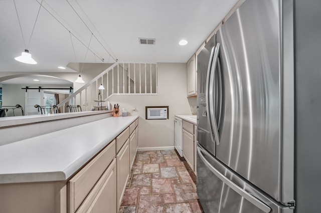 3123 Fairgrove Ter, Rochester Hills, MI 48309 - kitchen with white appliances, baseboards, stone tile floors, a barn door, and light countertops