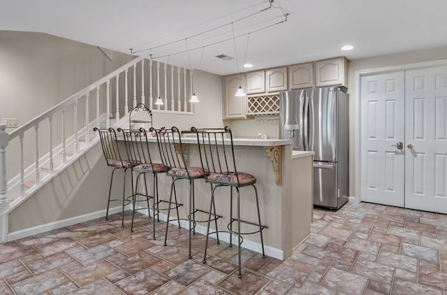 3123 Fairgrove Ter, Rochester Hills, MI 48309 - kitchen with stainless steel fridge with ice dispenser, a breakfast bar area, a peninsula, light stone finish floors, and recessed lighting