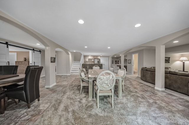 3123 Fairgrove Ter, Rochester Hills, MI 48309 - dining area with a barn door, stairs, recessed lighting, arched walkways, and baseboards