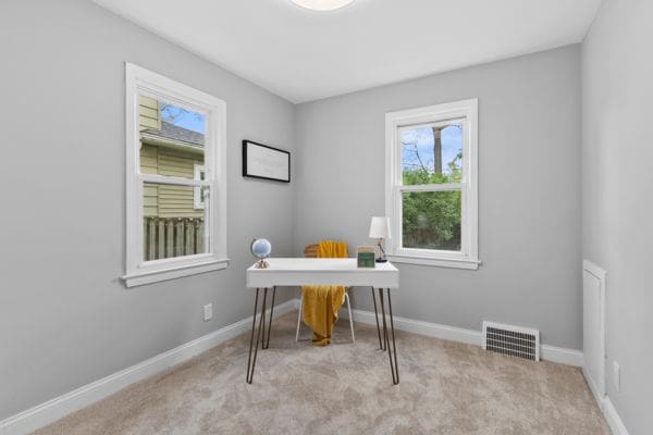 carpeted office space with baseboards