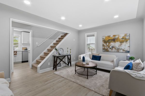 living room featuring stairway, light wood-type flooring, recessed lighting, and baseboards