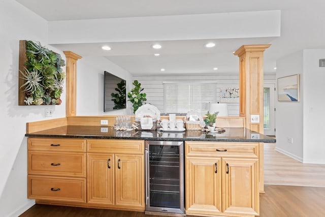 12147 Torrey Rd, Fenton, MI 48430 - bar with wine cooler, wood finished floors, recessed lighting, ornate columns, and baseboards