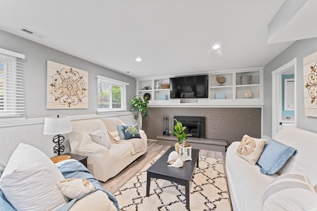 12147 Torrey Rd, Fenton, MI 48430 - living area featuring wood finished floors, recessed lighting, and a brick fireplace