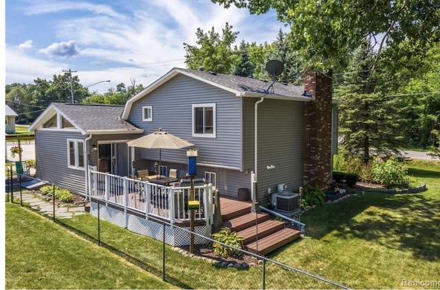 12147 Torrey Rd, Fenton, MI 48430 - back of house featuring central AC, a chimney, a wooden deck, and a yard