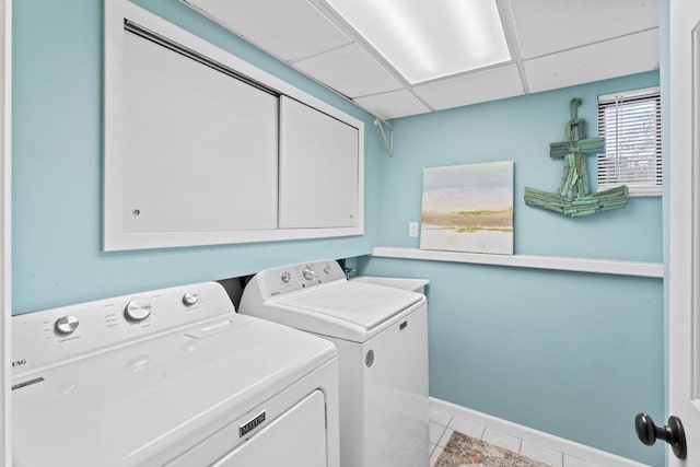 12147 Torrey Rd, Fenton, MI 48430 - laundry area featuring washer and clothes dryer, cabinet space, tile patterned floors, and baseboards