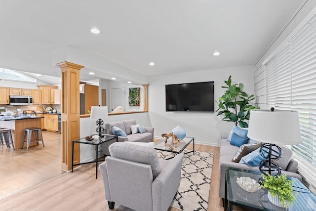 12147 Torrey Rd, Fenton, MI 48430 - living area featuring light wood-style flooring, ornate columns, recessed lighting, and baseboards