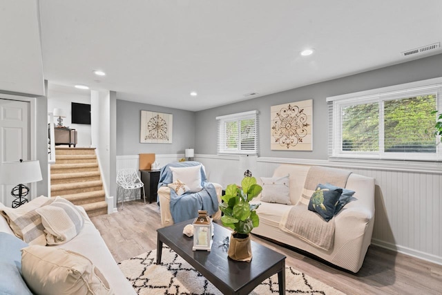 12147 Torrey Rd, Fenton, MI 48430 - living area with wainscoting, light wood-style floors, stairway, and recessed lighting