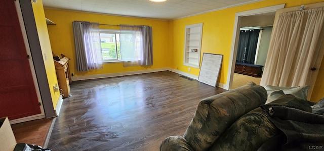 10320 Springville Hwy, Onsted, MI 49265 - living room with ornamental molding, dark wood finished floors, baseboards, and built in shelves
