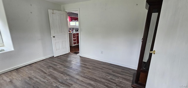 10320 Springville Hwy, Onsted, MI 49265 - unfurnished bedroom featuring dark wood-type flooring and baseboards
