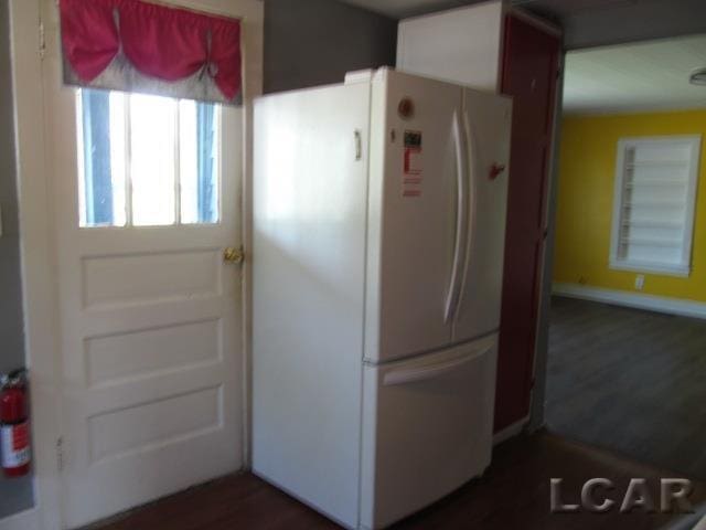 10320 Springville Hwy, Onsted, MI 49265 - kitchen featuring freestanding refrigerator, baseboards, and dark wood-style flooring
