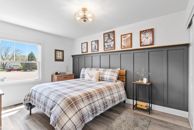 14043 Landings Way, Fenton, MI 48430 - bedroom with wood finished floors, a chandelier, and baseboards