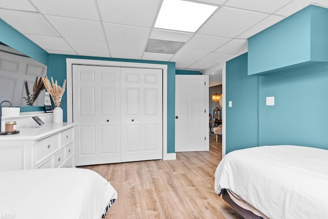 14043 Landings Way, Fenton, MI 48430 - bedroom with a closet, light wood-type flooring, and a paneled ceiling