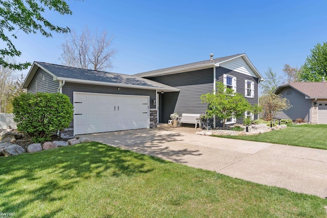 14043 Landings Way, Fenton, MI 48430 - split level home with an attached garage, concrete driveway, a front lawn, and roof with shingles