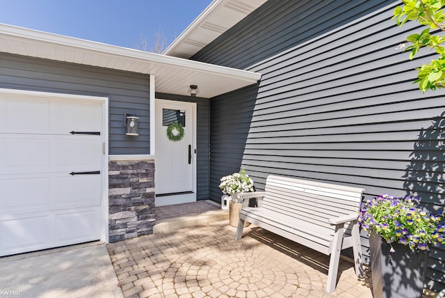 14043 Landings Way, Fenton, MI 48430 - doorway to property with a garage and stone siding