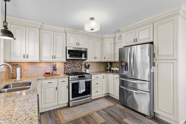 14043 Landings Way, Fenton, MI 48430 - kitchen with stainless steel appliances, a sink, dark wood-type flooring, tasteful backsplash, and light stone countertops