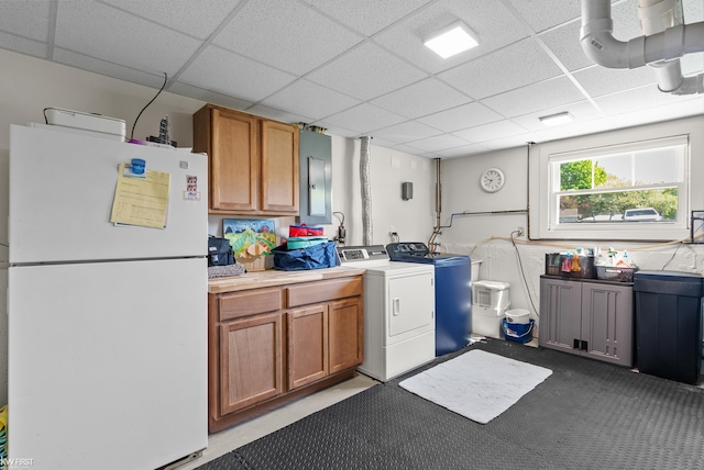 14043 Landings Way, Fenton, MI 48430 - kitchen with freestanding refrigerator, a paneled ceiling, light countertops, washing machine and dryer, and brown cabinetry