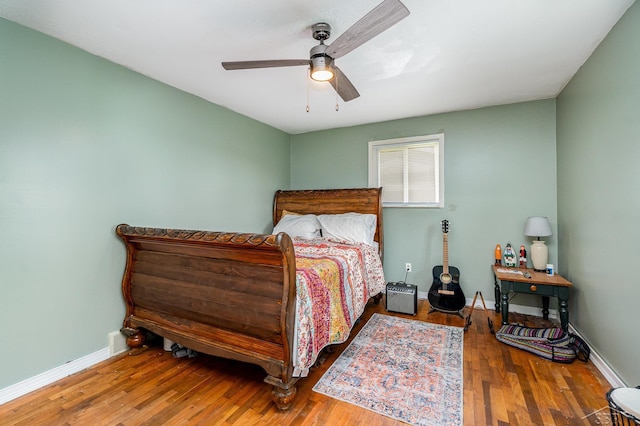 bedroom with wood finished floors, baseboards, and ceiling fan