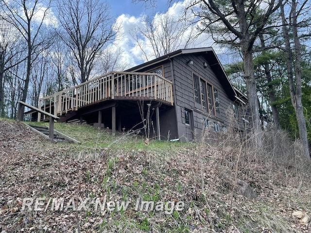 724 W Tobacco Ridge Trl, Beaverton, MI 48612 - view of side of home with a wooden deck