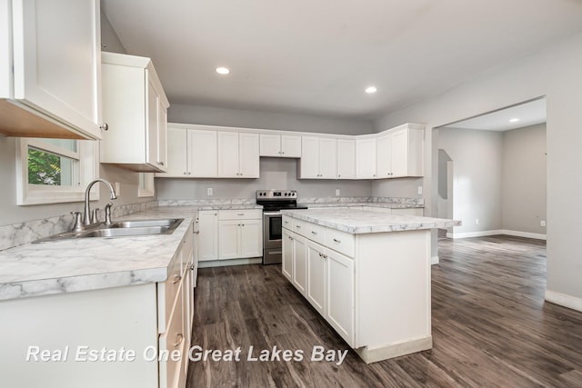1006 Cass Ave, Bay City, MI 48708 - kitchen featuring stainless steel range with electric stovetop, a sink, light countertops, dark wood-style flooring, and baseboards