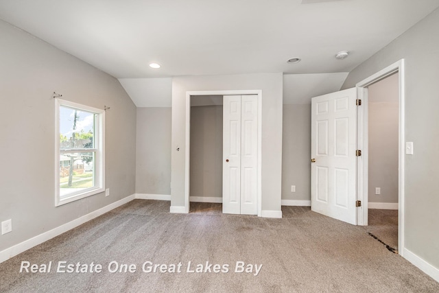 1006 Cass Ave, Bay City, MI 48708 - unfurnished bedroom featuring carpet, a closet, recessed lighting, baseboards, and vaulted ceiling