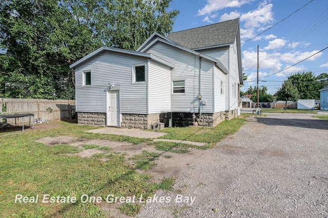 1006 Cass Ave, Bay City, MI 48708 - view of side of home with fence and roof with shingles