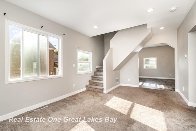 1006 Cass Ave, Bay City, MI 48708 - unfurnished living room with carpet, stairway, baseboards, and recessed lighting