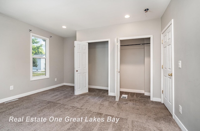1006 Cass Ave, Bay City, MI 48708 - unfurnished bedroom featuring carpet, two closets, baseboards, and recessed lighting