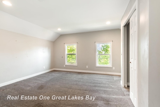 1006 Cass Ave, Bay City, MI 48708 - spare room with carpet flooring, recessed lighting, vaulted ceiling, and baseboards