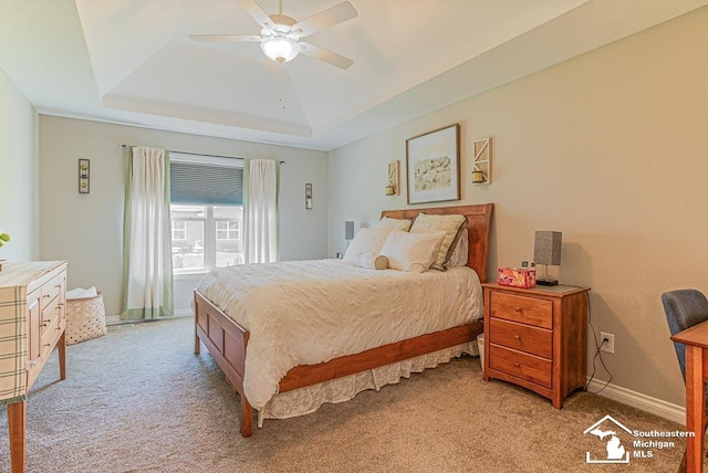 8265 Grande Lake Cir, Temperance, MI 48182 - bedroom with a tray ceiling, light colored carpet, ceiling fan, and baseboards