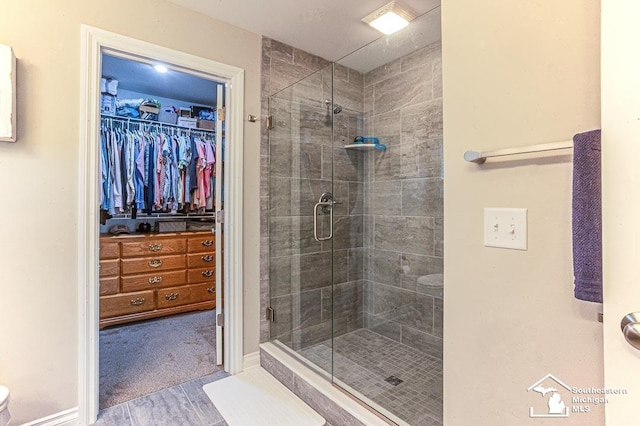 8265 Grande Lake Cir, Temperance, MI 48182 - full bathroom featuring a shower stall, wood finished floors, and a spacious closet
