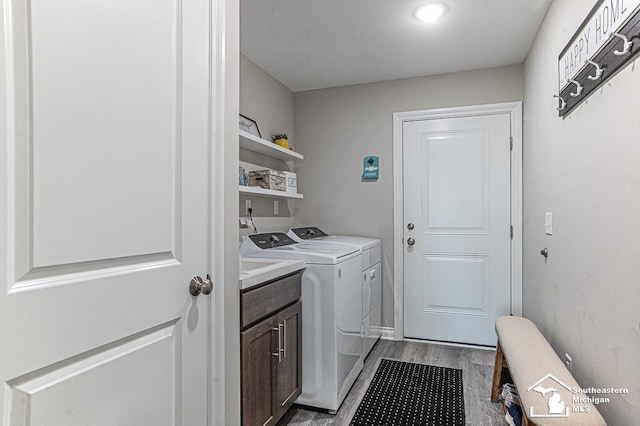 8265 Grande Lake Cir, Temperance, MI 48182 - laundry area with independent washer and dryer, light wood-style floors, and cabinet space