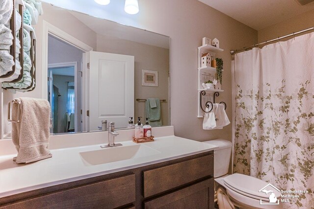 8265 Grande Lake Cir, Temperance, MI 48182 - bathroom featuring toilet, vanity, and a shower with shower curtain