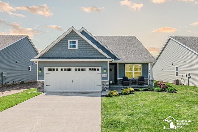 8265 Grande Lake Cir, Temperance, MI 48182 - craftsman-style home featuring a porch, stone siding, driveway, a front yard, and a garage