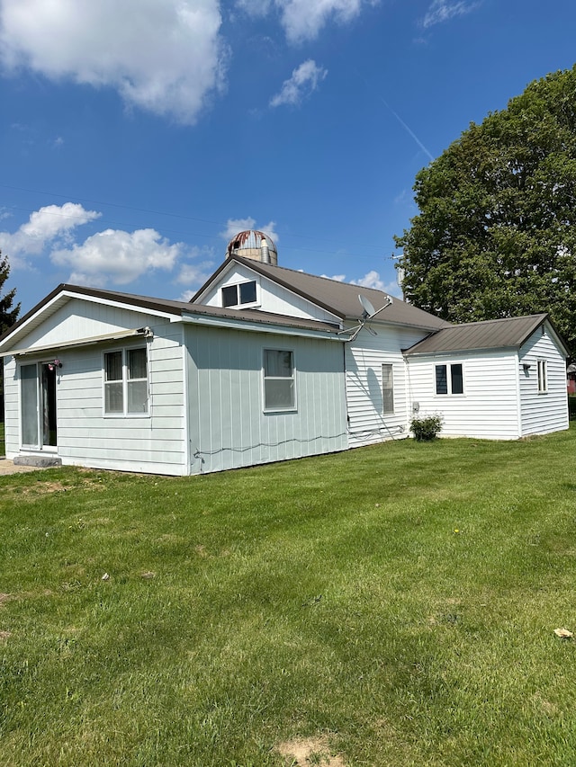 9548 Sharp Rd, Clifford, MI 48727 - rear view of house with a yard and metal roof