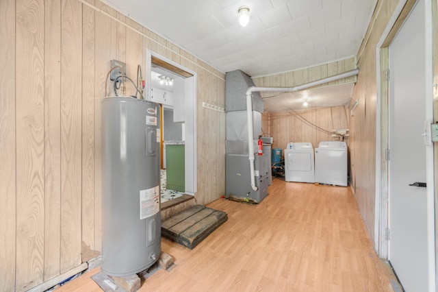 237 Main St, Walkerville, MI 49459 - finished below grade area featuring electric water heater, wood finished floors, washer and dryer, heating unit, and wooden walls