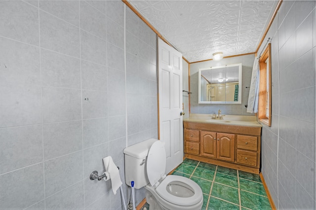 237 Main St, Walkerville, MI 49459 - bathroom with toilet, vanity, tile patterned flooring, crown molding, and tile walls